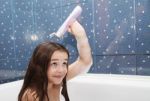 Little Girl Holding A Bottle Of Shampoo Stock Photo