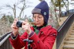 Women In Red Coat Taking A Photo At Japan Garden Stock Photo