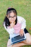 Lovely Girl With A Laptop On The Grass Stock Photo