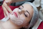 Woman Having Facial Mask At Beauty Salon Stock Photo