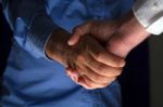 Handshake Handshaking In Dark With Low Light Stock Photo