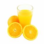 Glass Of Orange Juice And Two Riped Fruit Side On White Background Stock Photo