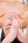 Young Man Getting A Face Massage From Masseuse Stock Photo