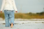 Walking Barefoot On The Beach Stock Photo