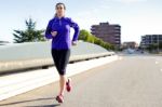 Pretty Young Woman Running In City Stock Photo