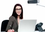 Happy Young Woman Working In Office Stock Photo