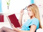 Woman Reading Book At Home Stock Photo