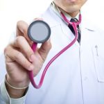 Doctor Holding Stethoscope Stock Photo