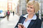 Corporate Woman Operating Her Cellphone Stock Photo