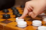 Finger Moves The Piece To The Chessboard Stock Photo