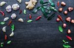 Top View Of Food Ingredients And Condiment On The Table, Ingredients And Seasoning On Dark Wooden Floor Stock Photo