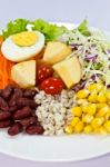 Fruit Salad With Boiled Egg On A White Plate Stock Photo