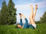 Young Woman Using Mobile Phone In Park Stock Photo