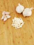 Garlic Preparation Ways On A Cutting Board Stock Photo