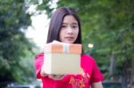 Portrait Of Thai Teen Beautiful Girl In Chinese Dress, Happy New Year And Open Box Gift, Smile And Very Happy Stock Photo