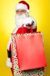 Cheerful Santa Holding Vibrant Colored Shopping Bags Stock Photo