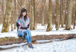 Young Beautiful Woman Walking Under A Snowfall Stock Photo