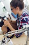 Young Woman Photographer Checking Previews On Camera In The Stud Stock Photo