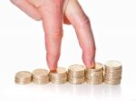 Fingers Walking Up On Stacks Of One Pound Coins Stock Photo