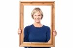 Middle Aged Lady Holding Photo Frame Stock Photo