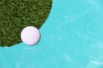 Golf Ball Edge Of Grass Field And Water Stock Photo