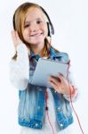 Beautiful Child Listening To Music With Digital Tablet Stock Photo