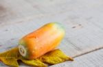 Papaya On Wooden Floor Stock Photo