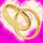 Golden Rings On Pink Heart Stock Photo