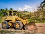 Yellow Tractor On The Road Stock Photo