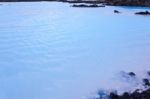 Milky White And Blue Water Between The Lava Stones Covered With Moss Stock Photo