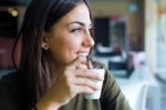 Beautiful Girl Drinking Coffee Sitting Indoor In Urban Cafe Stock Photo