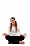 Young Woman Doing Meditation With Music Stock Photo