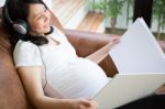 Pregnant Woman Listen To The Music Stock Photo