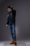 Casual Young Man In Black Leather Jacket And Denim Jeans Stock Photo