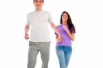 Smiling Teenage Couple Running Stock Photo