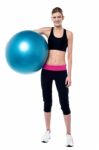 Female Fitness Trainer Holding Aerobic Ball Stock Photo