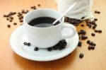 Cup Of Coffee And Part Bag Beans On Wooden Table Stock Photo