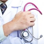 Doctor Holding Stethoscope Stock Photo