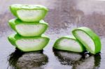 Slice Aloe Vera On Wet Wood Background Stock Photo