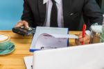 Business Man Sitting On A Calculator To Figure Out In A Coffee S Stock Photo