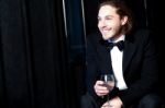 Handsome Smiling Man Holding A Glass Of Wine Stock Photo