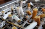 Many Left Smoked Cigarette Butts Fag-end In Ashtray On No Smoking Day Stock Photo