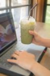 Woman Using Laptop In The Coffee Shop Stock Photo