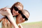 Young Couple Piggy Backing Stock Photo