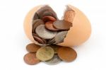 Broken Egg With Coins Stock Photo