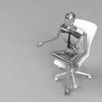 Businessman Doll Sitting On Chair Stock Photo