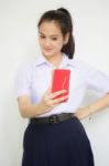 Portrait Of Thai High School Student Uniform Beautiful Girl Using Her Smart Phone Selfie Stock Photo