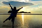 Women Happy Sunrise At The Beach Stock Photo