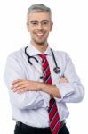 Experienced Doctor With Arms Crossed Stock Photo