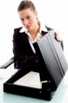 Businesswoman Putting Document In Briefcase Stock Photo